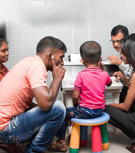 Family and child undergoing auditory response testing in dedicated clinic facility at Wickramarachchi Hearing Care